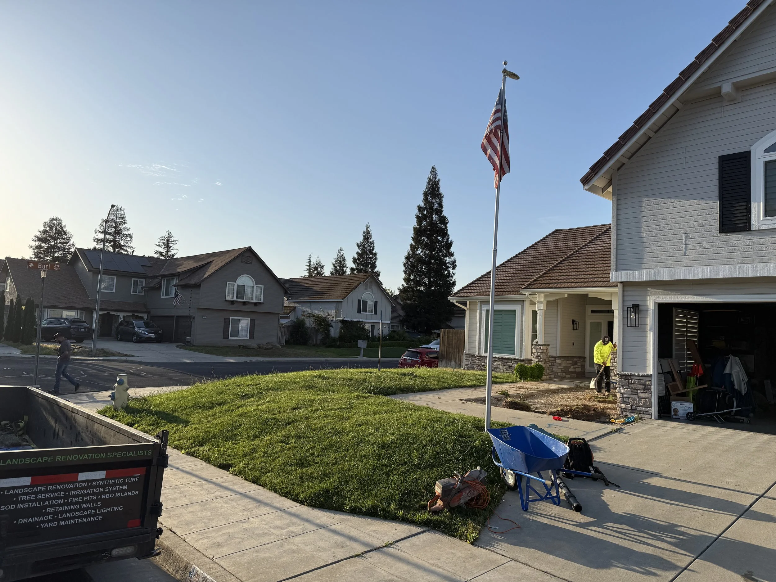 Specialty Landscape dump trailer listing services, parked at a Fresno-area job