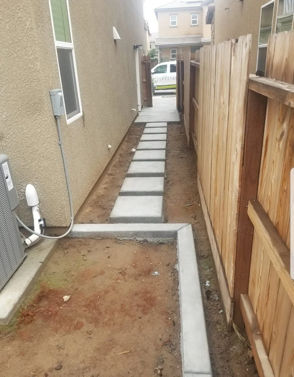 Gravel base and concrete pads set over a drainage run by Specialty Landscape