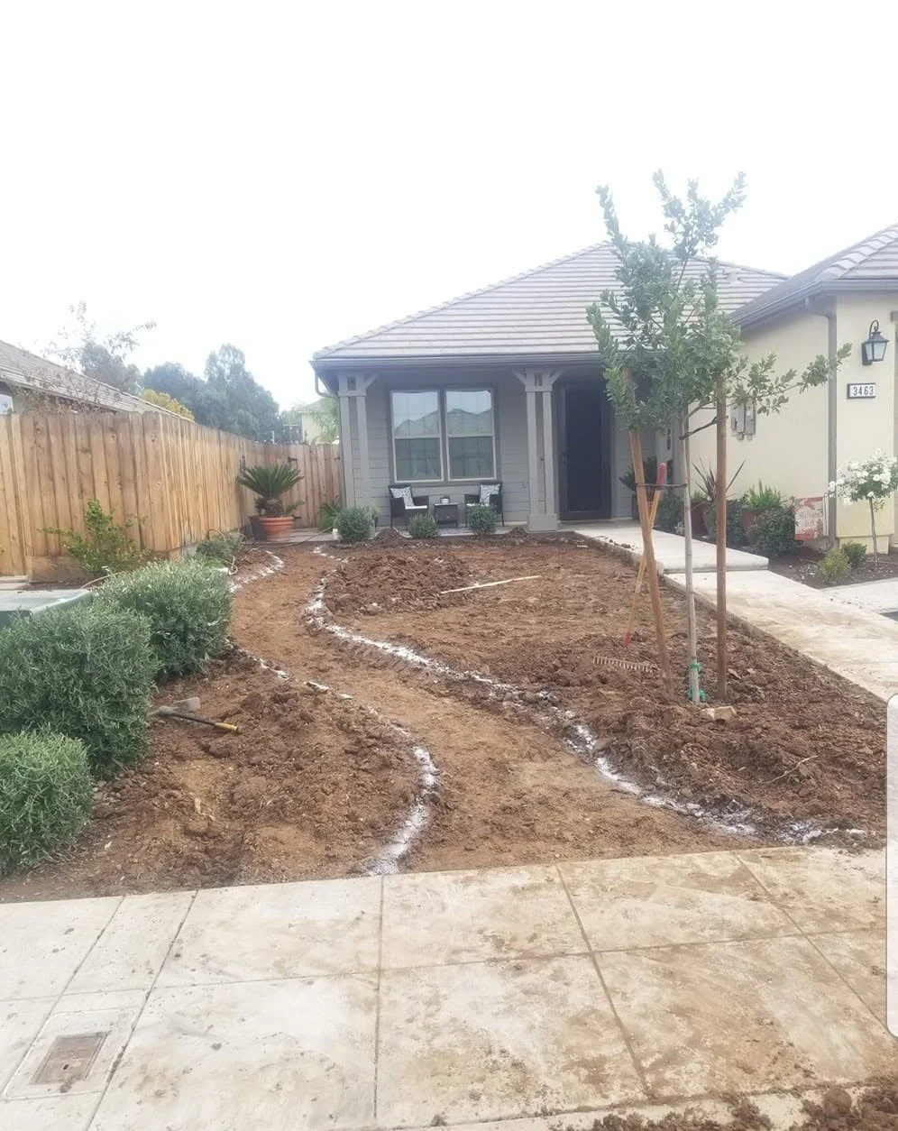 Gravel dry creek running beneath established trees by Specialty Landscape