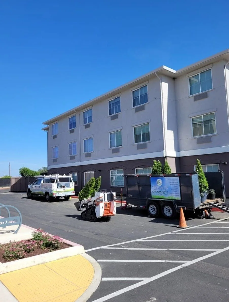 Specialty Landscape truck and trailer at a commercial property in Fresno