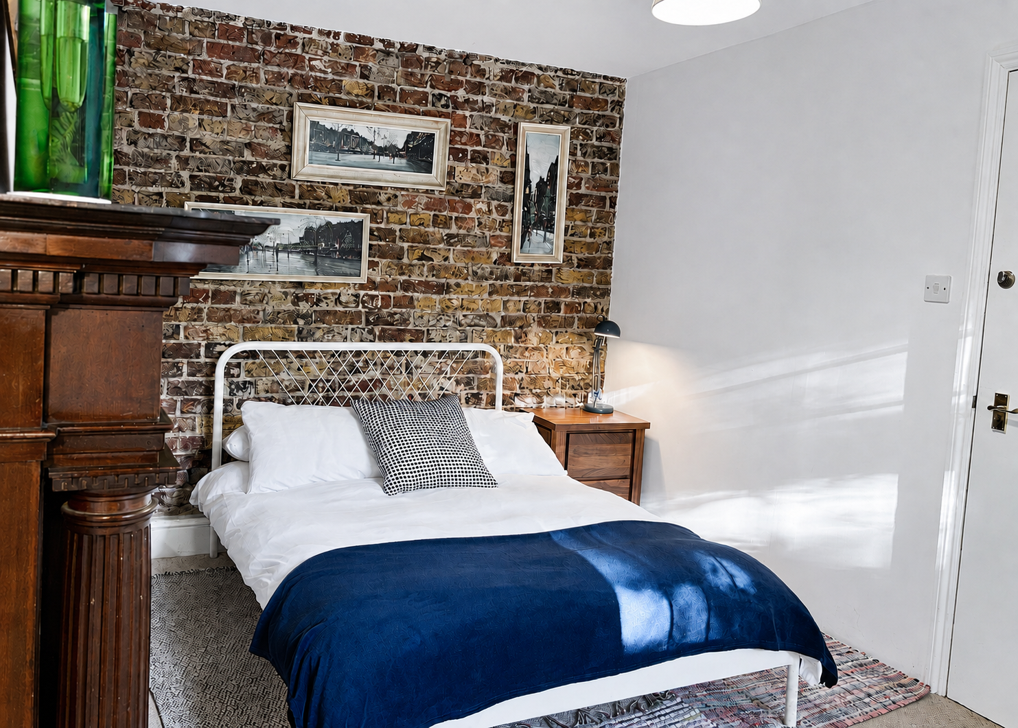 Room 6 garden-level double bedroom with exposed Victorian brickwork at Central Victorian House in Camden Town