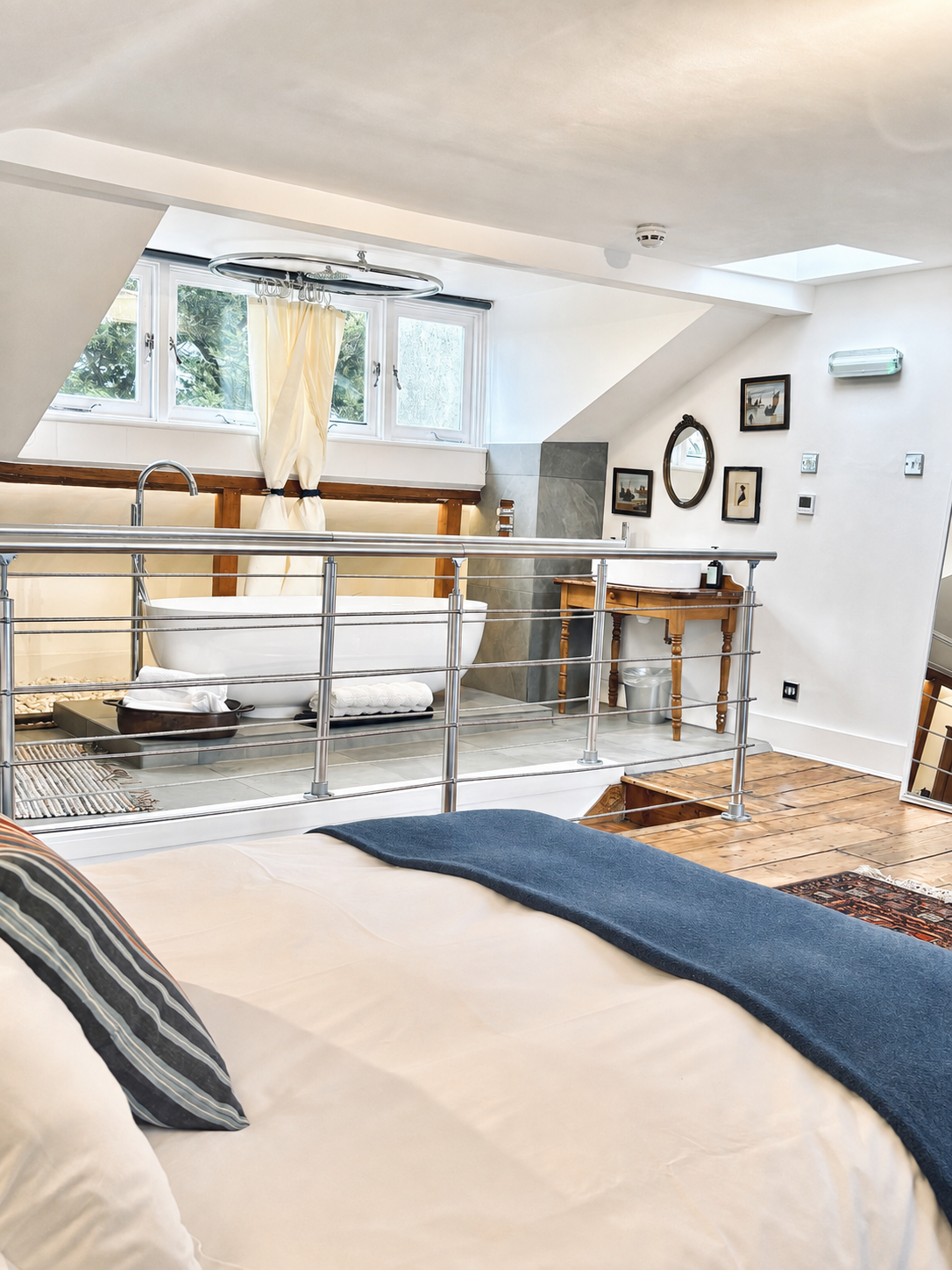 Room 101 top-floor ensuite studio with a double bed and freestanding bath at Central Victorian House in Camden Town