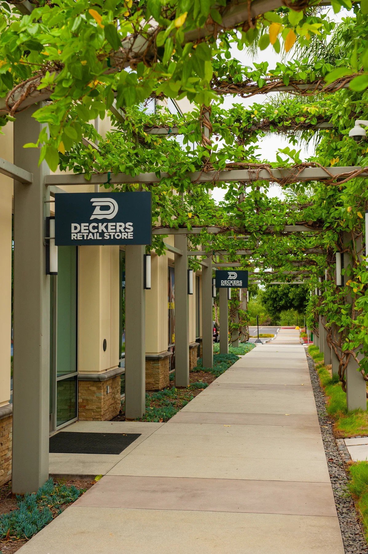 A vine-covered trellis shading the retail walkway at Cabrillo Business Park
