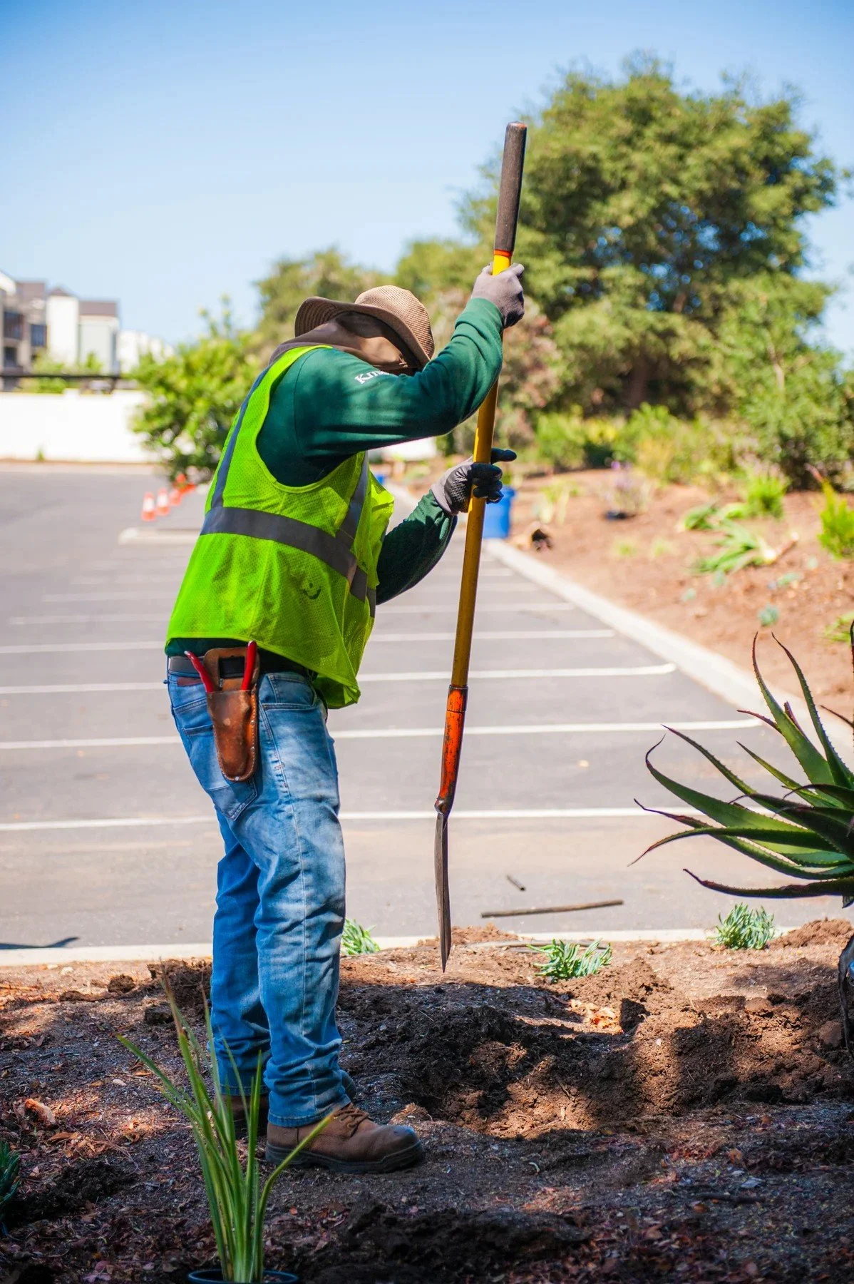 Kitson crew member working in a planting bed at 26 Castilian