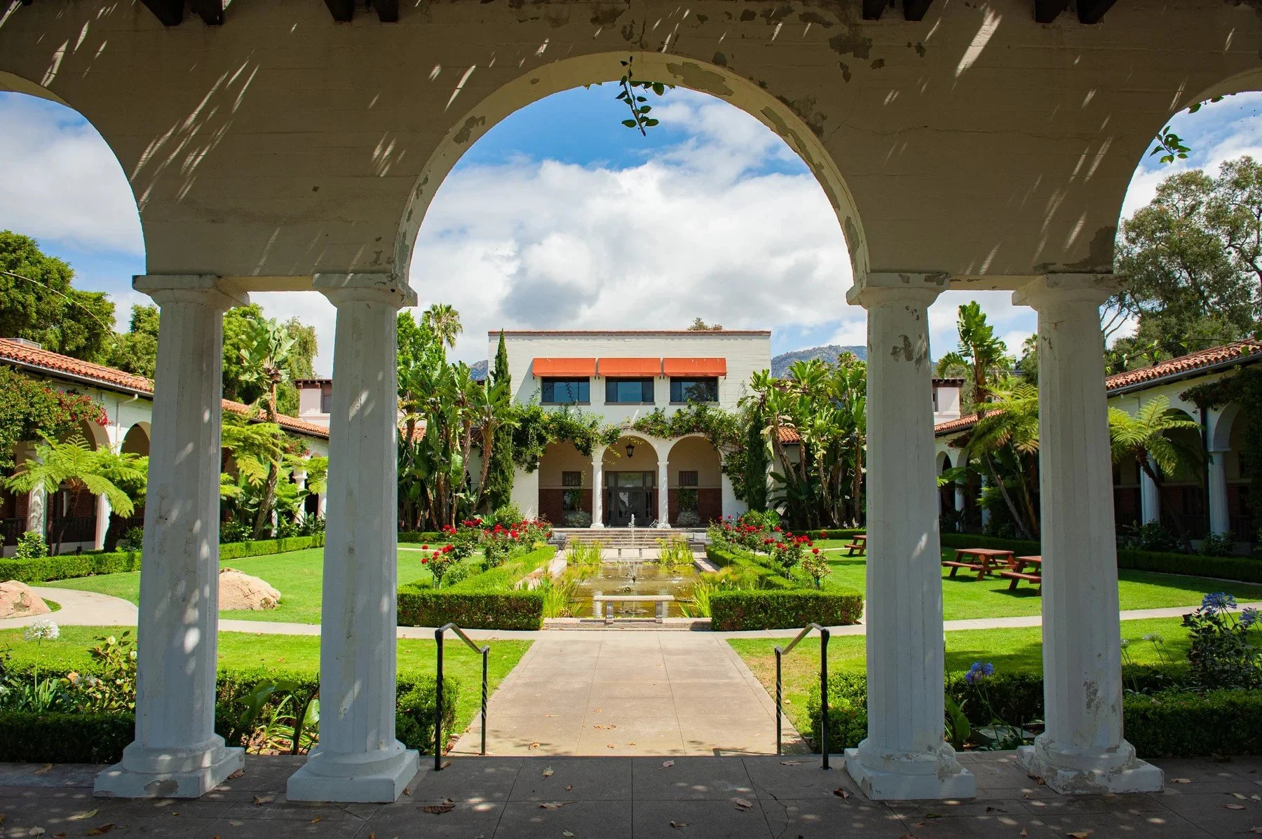 Arched colonnade framing a landscaped courtyard at Riviera Park