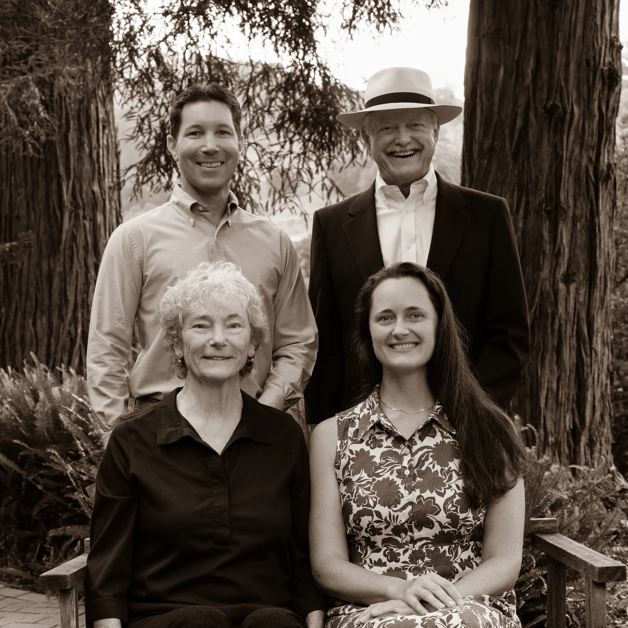 Sepia portrait of the Kitson founding family together among mature trees