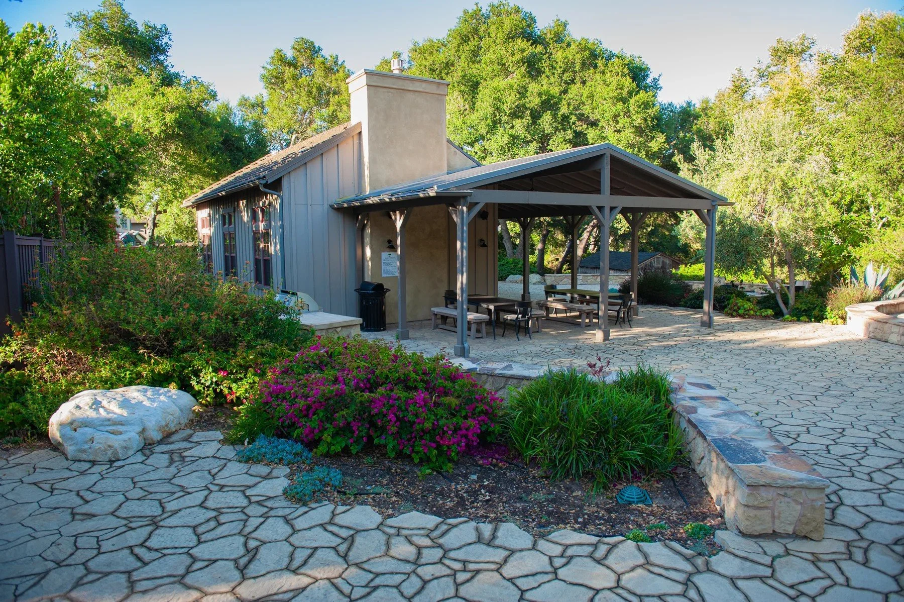 Outdoor pavilion and shared seating surrounded by gardens at Tree Farm