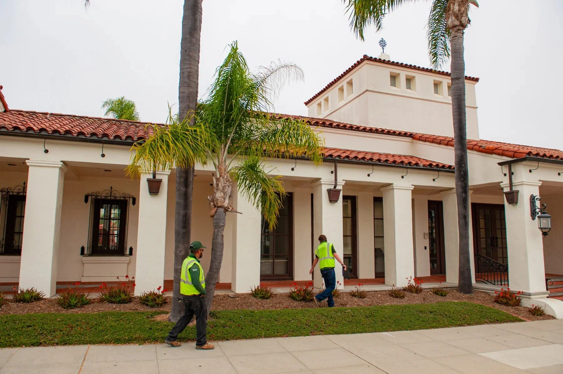 Two Kitson team members walking beside the landscaped frontage at 1424 State