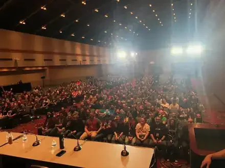 Satine in front of a large crowd