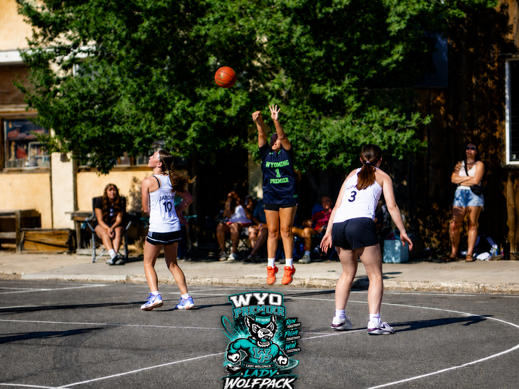 Lady Wolfpack player taking a jump shot
