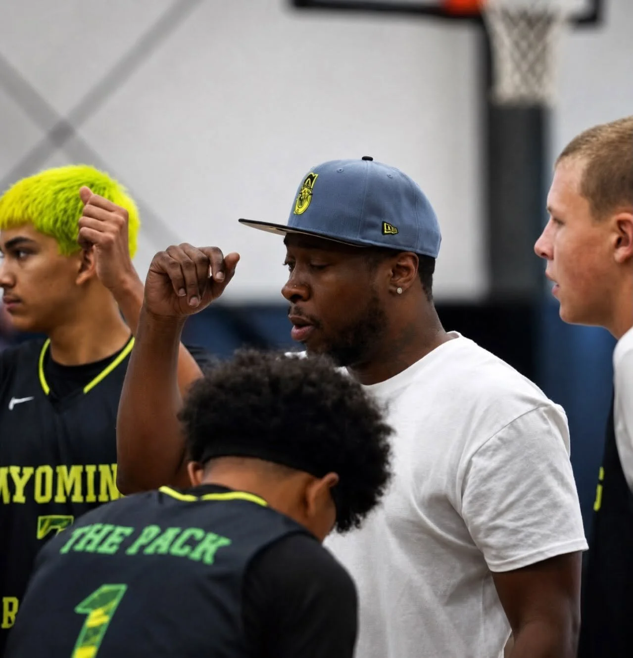Coach Eric Smith coaching Wyoming Premier Hoops players during a team huddle