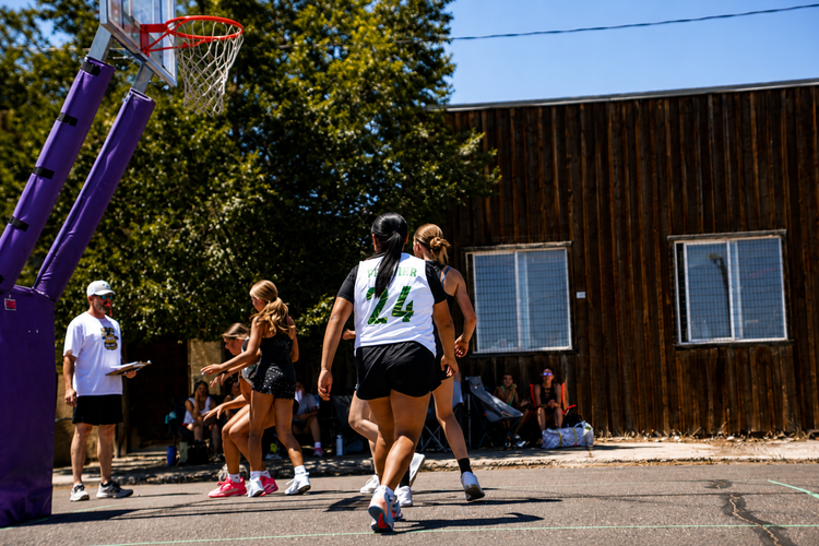 Lady Wolfpack players moving toward the basket