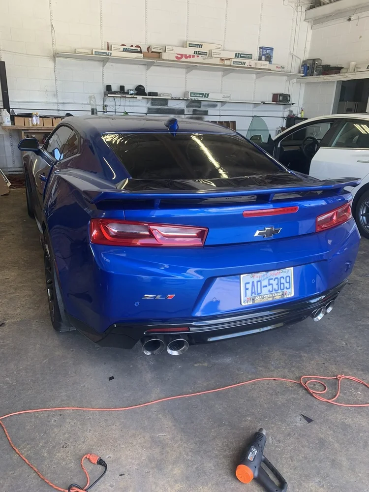 Blue Chevrolet Camaro SS with tinted windows inside the bay