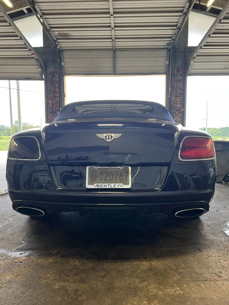 Rear of a dark Bentley Continental GT with tinted rear glass