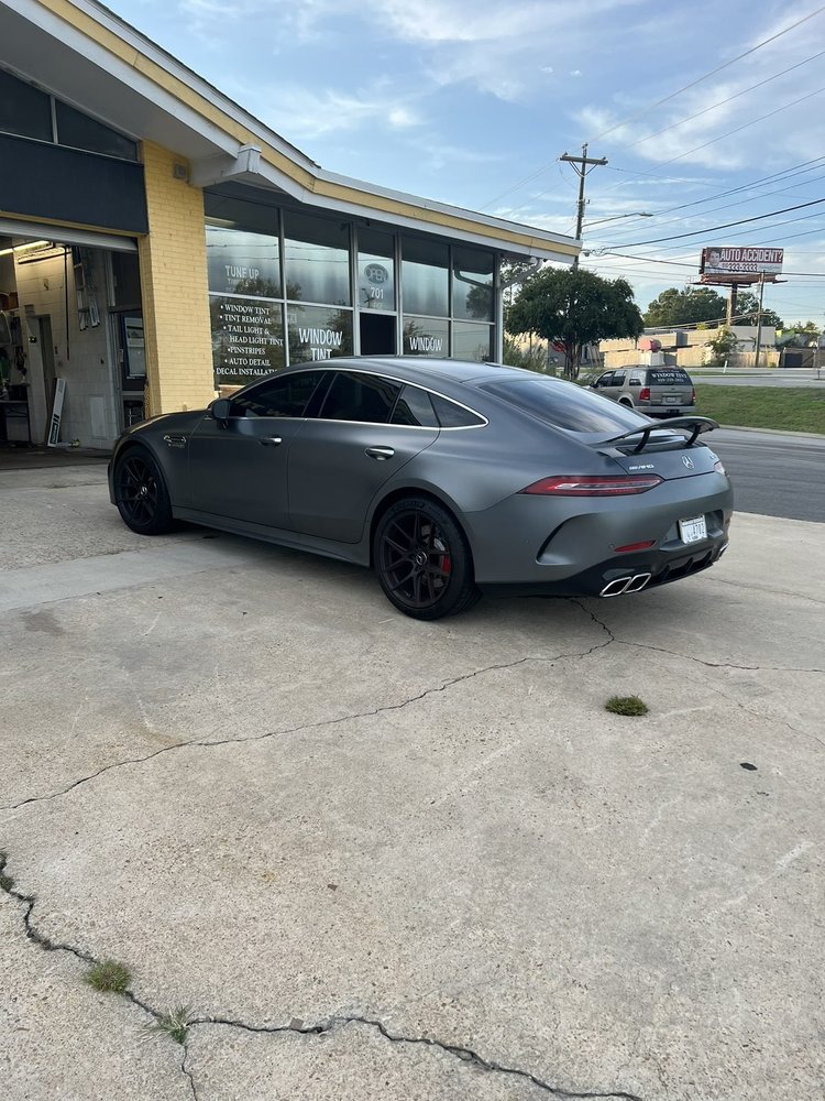 Grey Mercedes-AMG GT four-door coupe with tinted windows