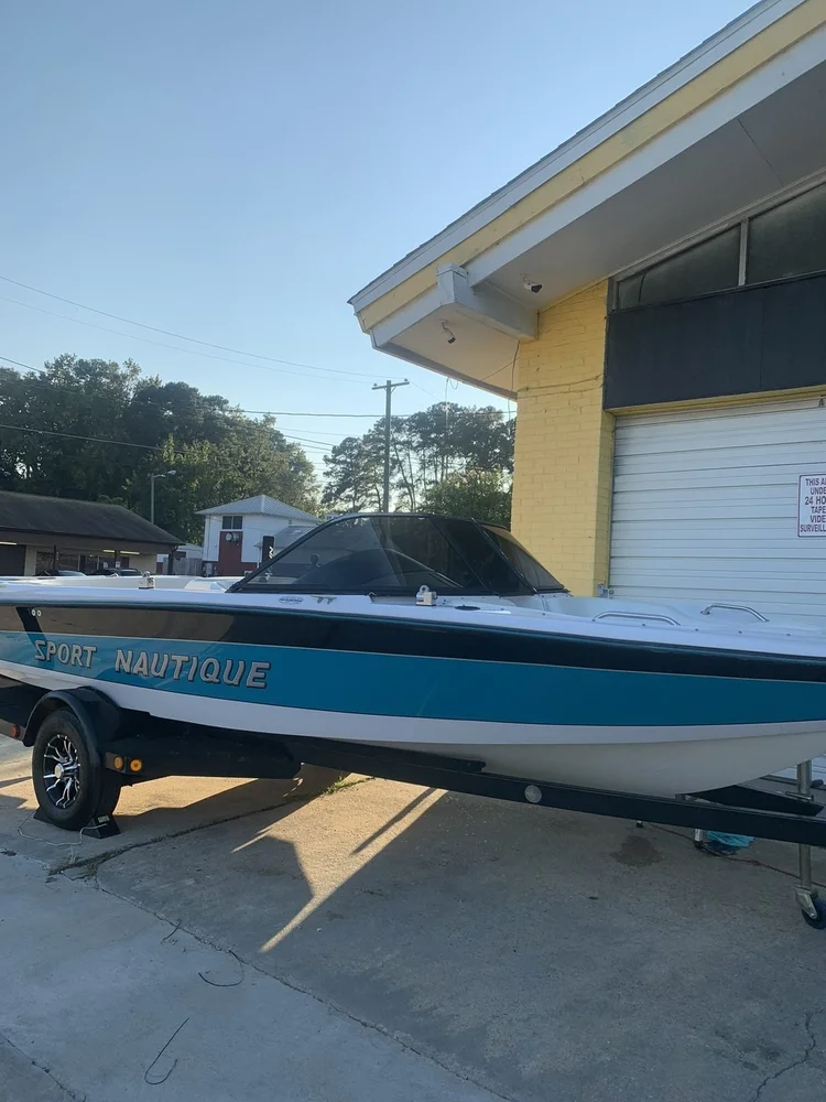 Nautique boat on a trailer outside Perfect Shade for windshield tint