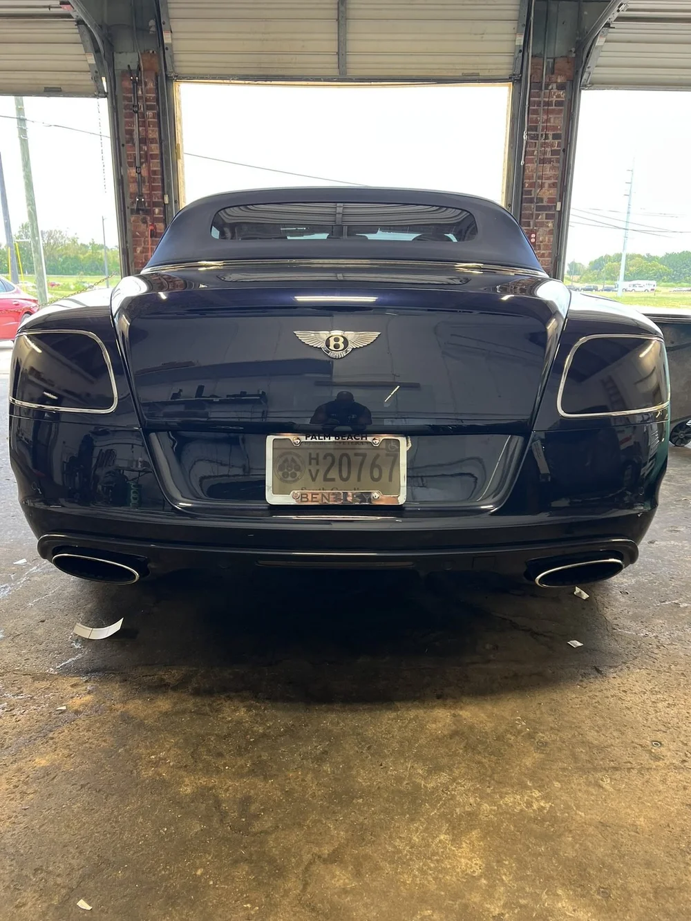 Rear view of a dark Bentley Continental GT with freshly tinted windows inside the Perfect Shade bay