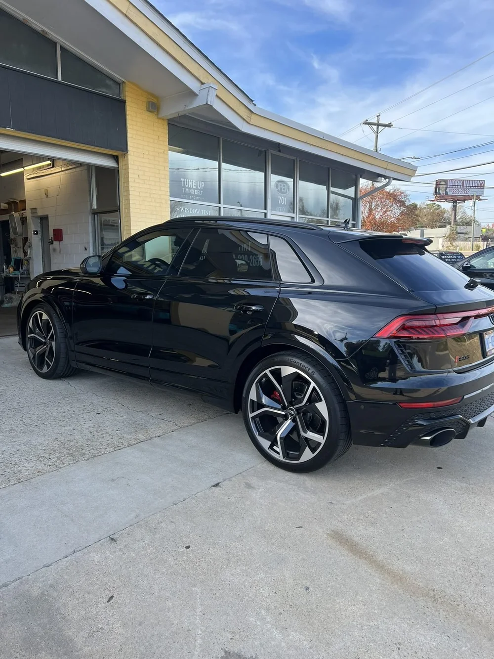 Black Audi Q8 with dark tinted windows parked outside Perfect Shade