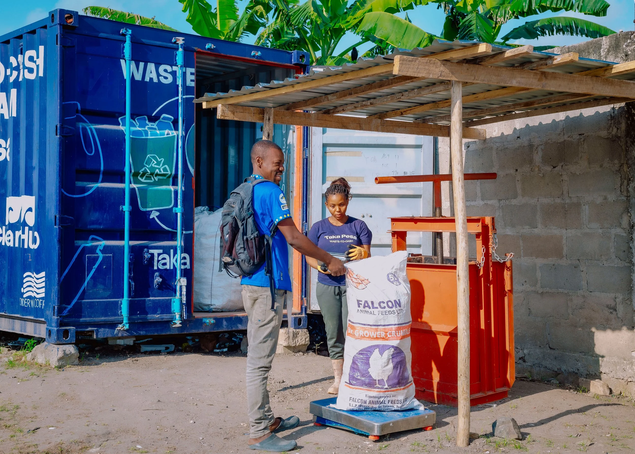 Taka Pesa team member weighing materials