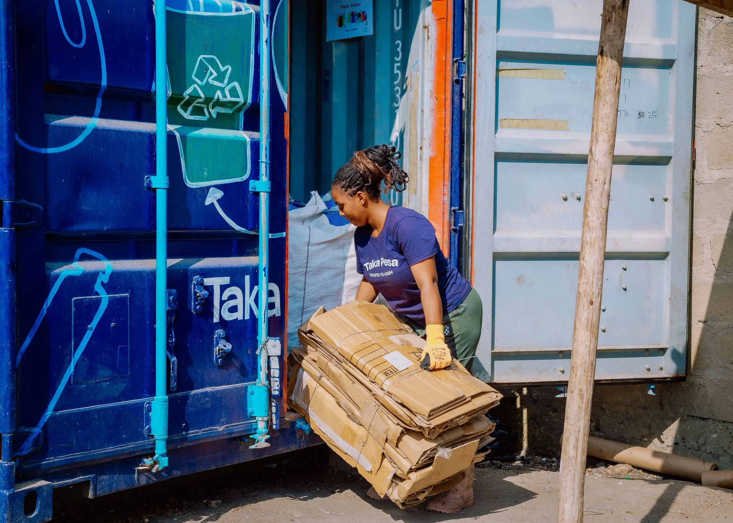Taka Pesa team member sorting recyclables