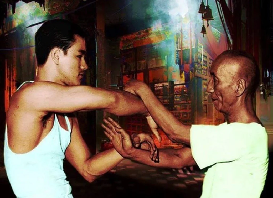 Bruce Lee doing chi sau with Ip Man.