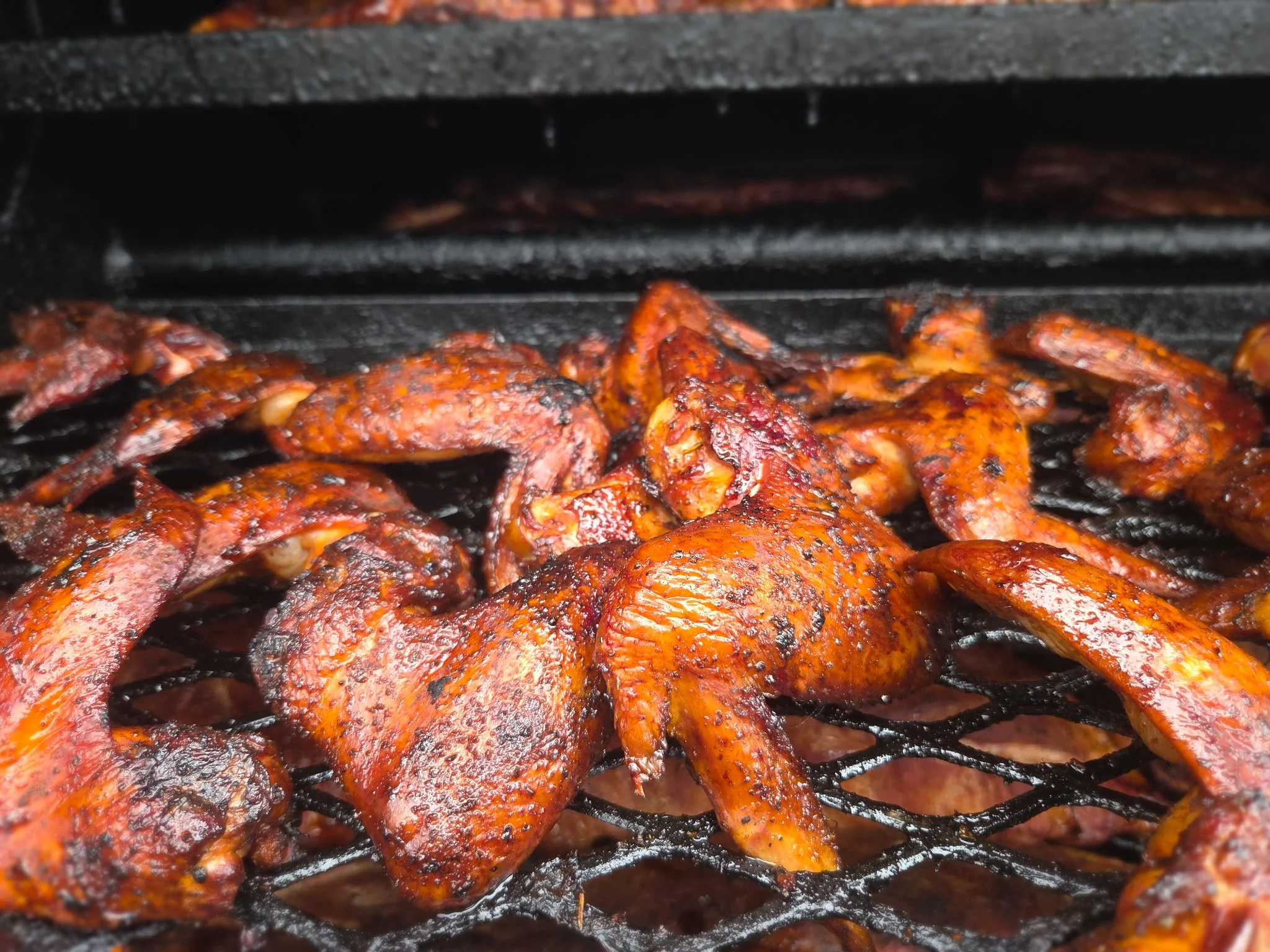 Jerk wings on the smoker grates