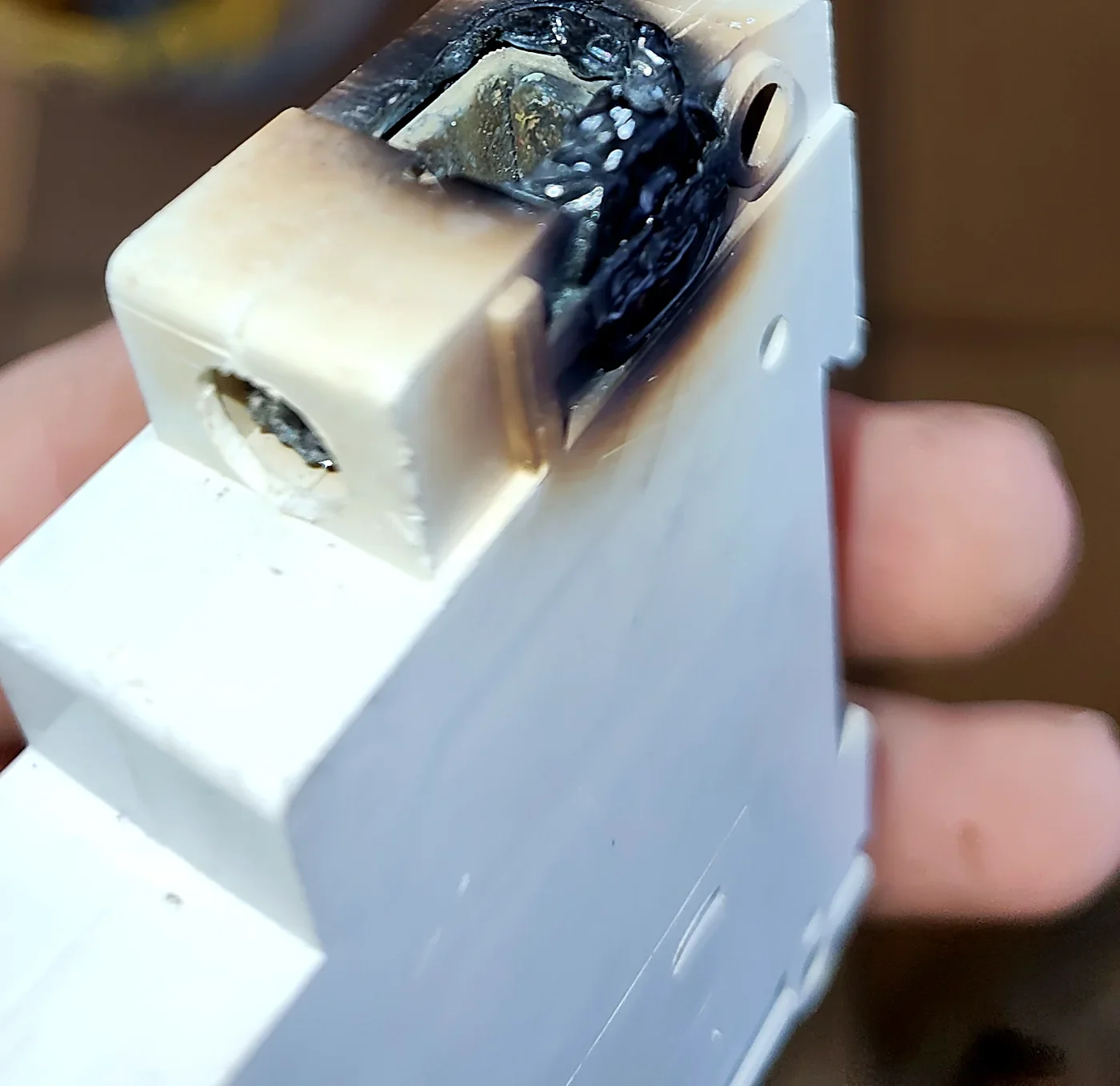 A burnt, melted circuit breaker found during a switchboard inspection