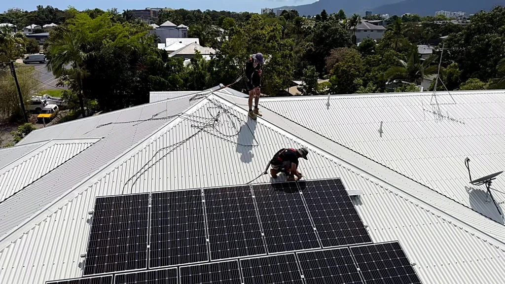 Drone view of solar panels being reinstalled on a metal roof in Cairns