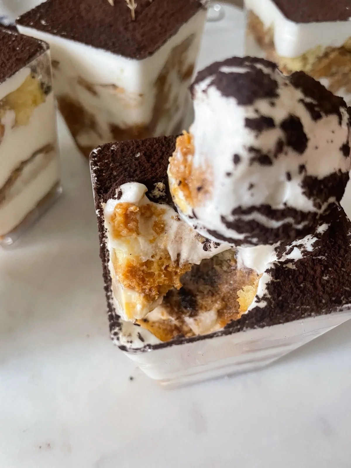 Tiramisu cup opened showing espresso-soaked pound cake and cream layers