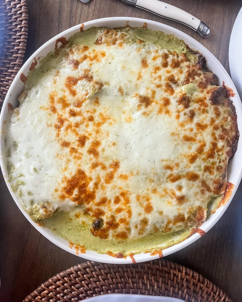 Enchiladas suizas fresh out of the oven with golden bubbling Monterrey cheese