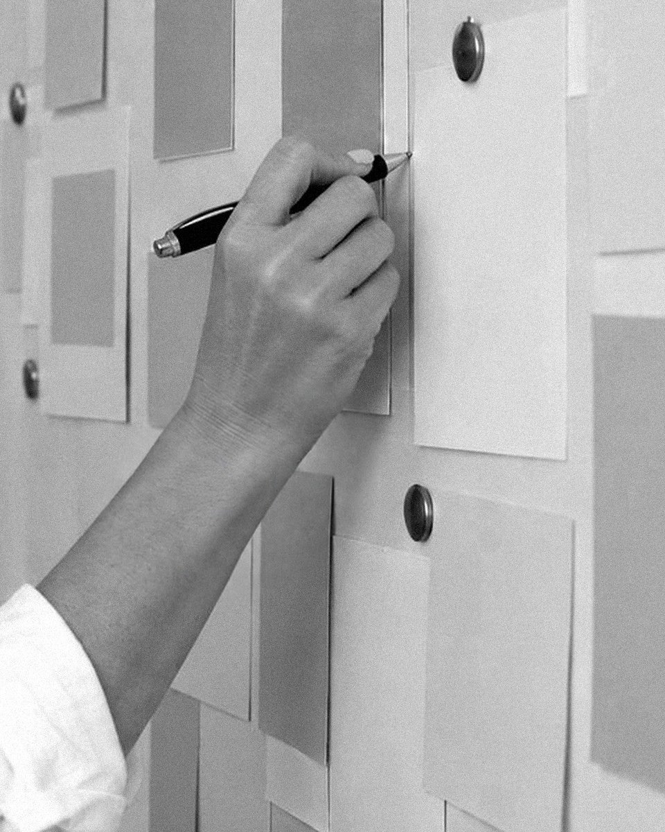 Black and white close-up of Caroline's hand mapping a roadmap on cards