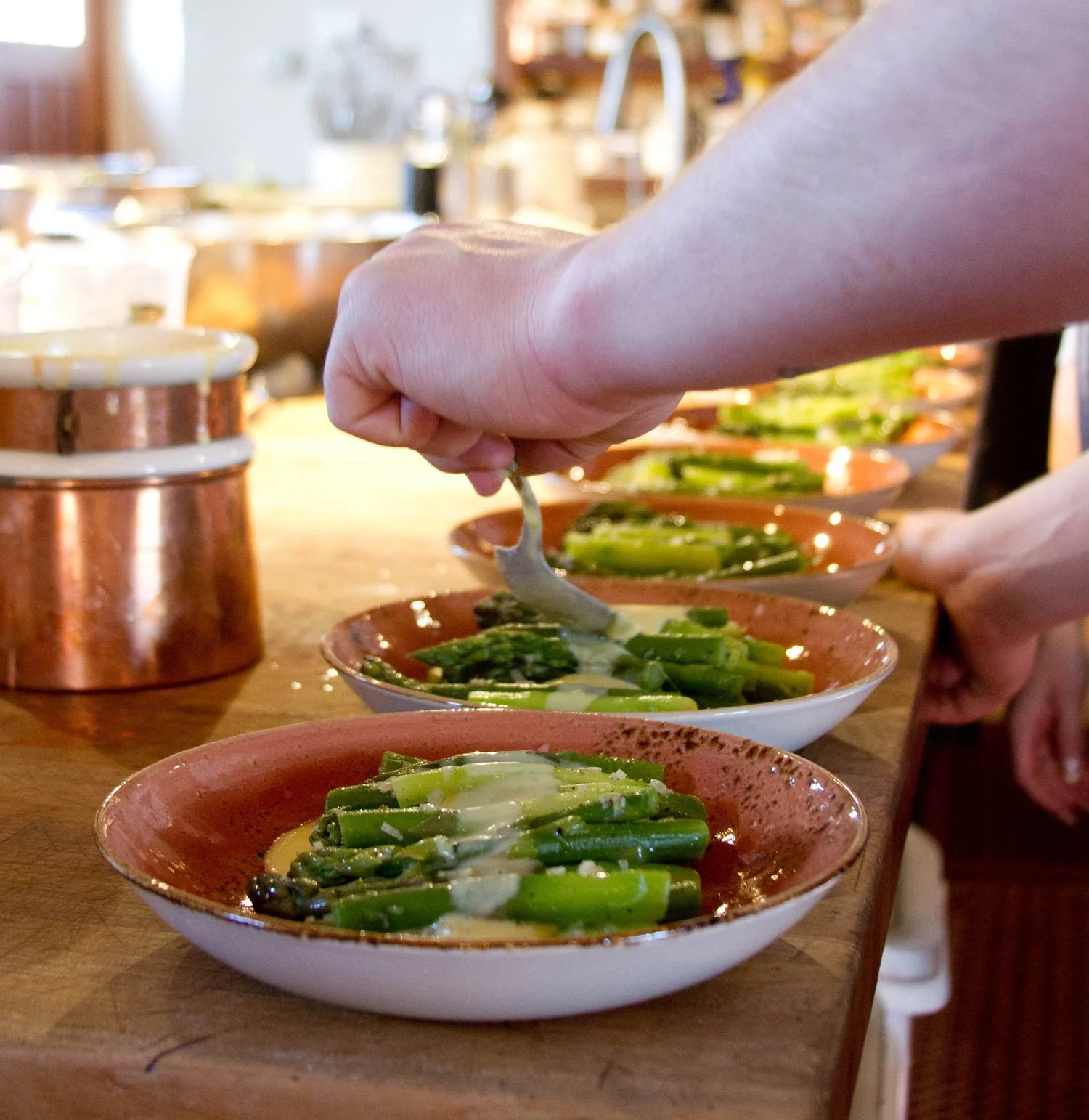 Asparagus dishes being prepared by chef