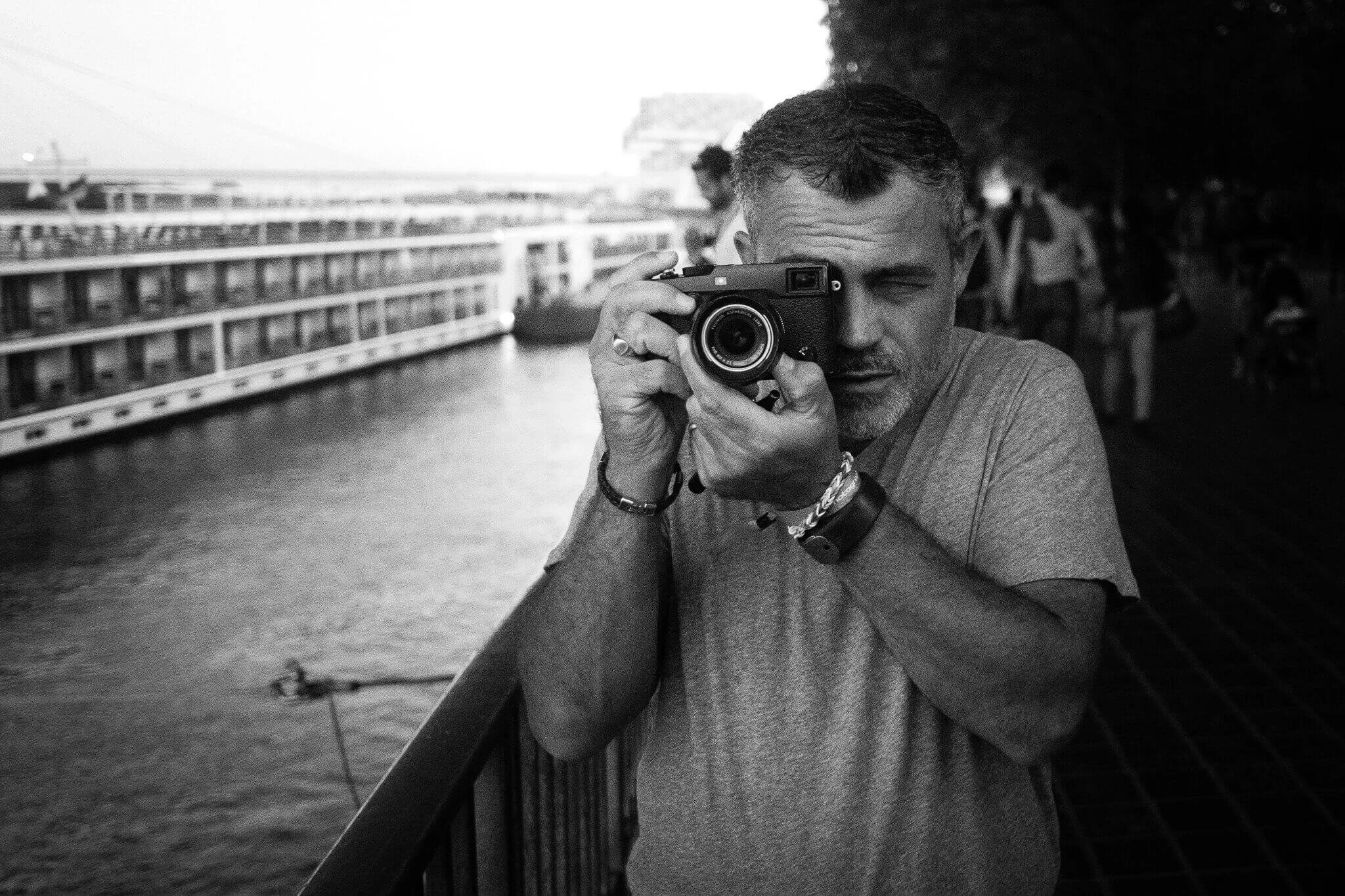 Photographer Kevin Mullins holding a Fujifilm Camera