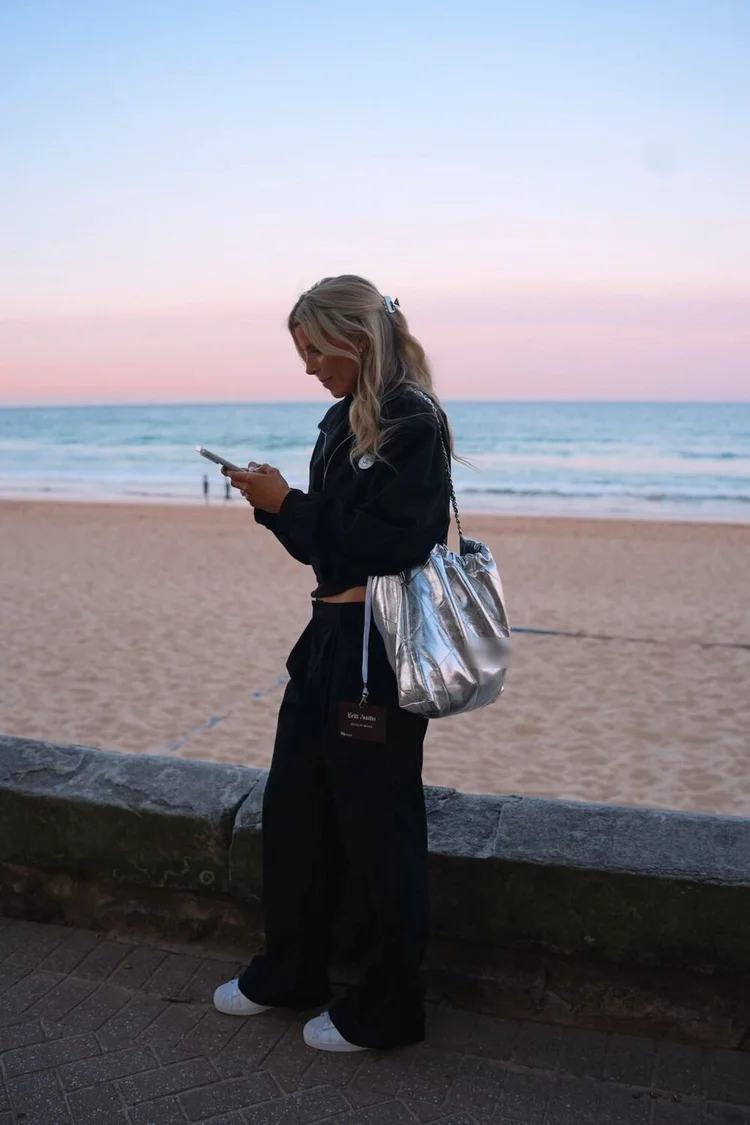 Britt on her phone at the beach
