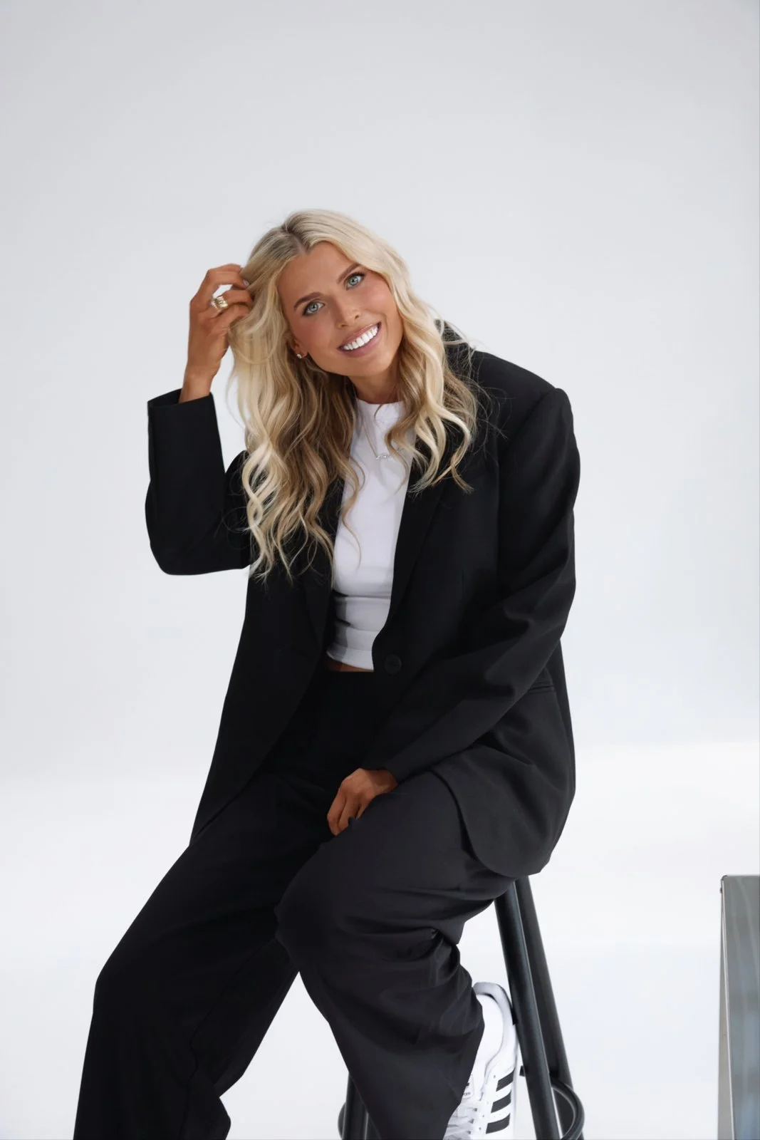 Britt Austin in a black suit in the studio