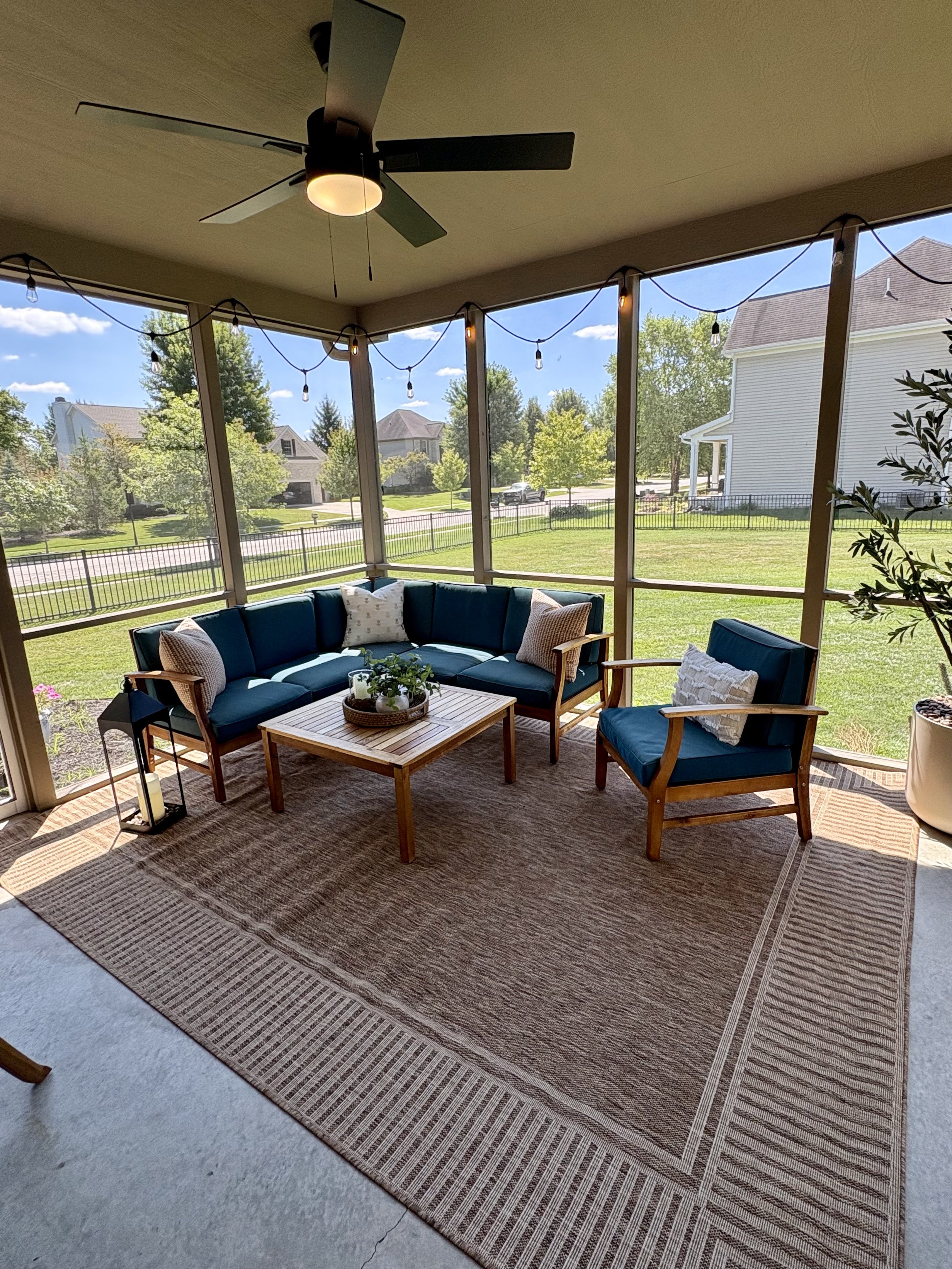 Professionally designed screened porch with furniture, lighting and outdoor décor