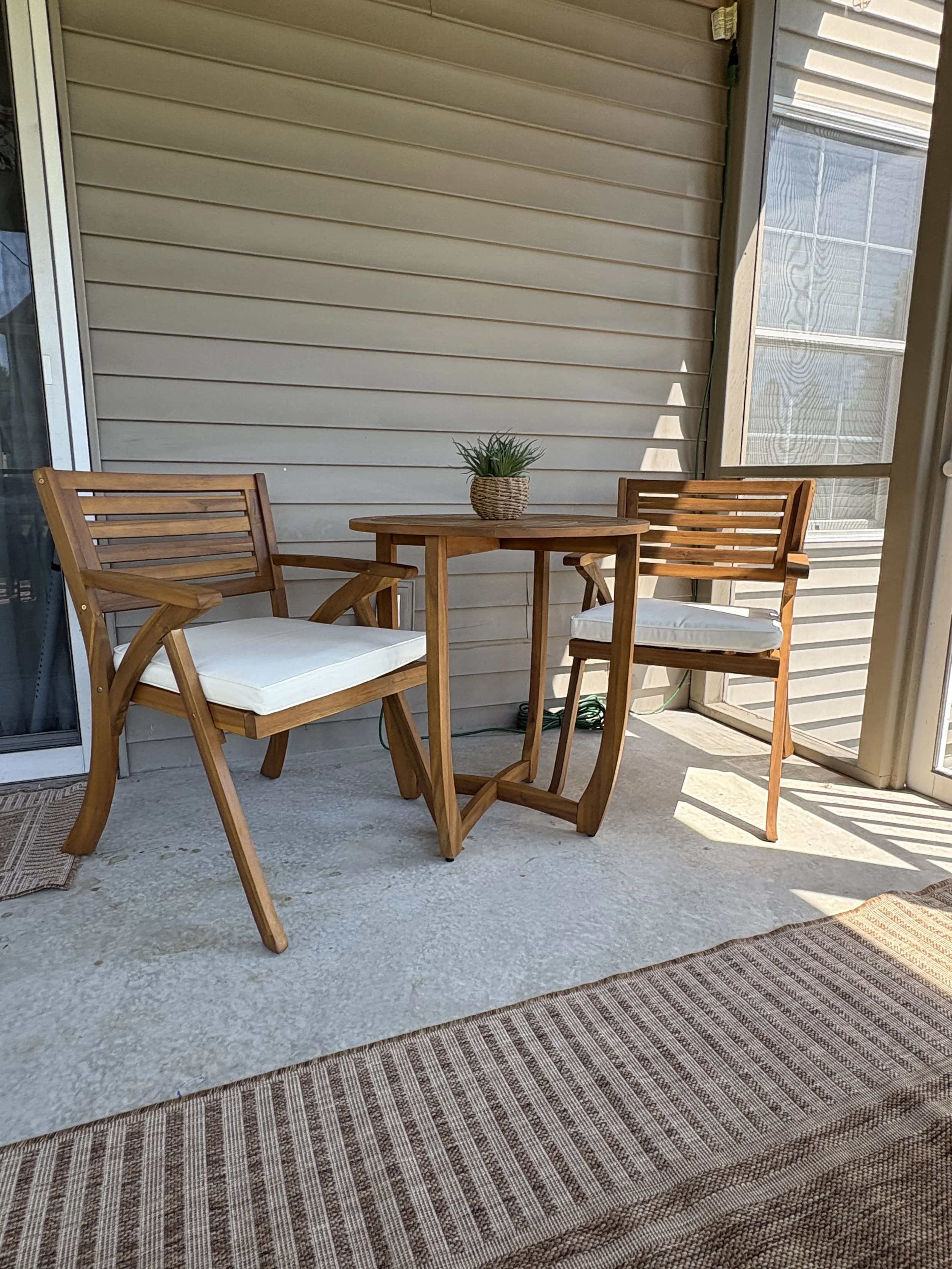 Outdoor living space with coordinated furniture, rug and lighting