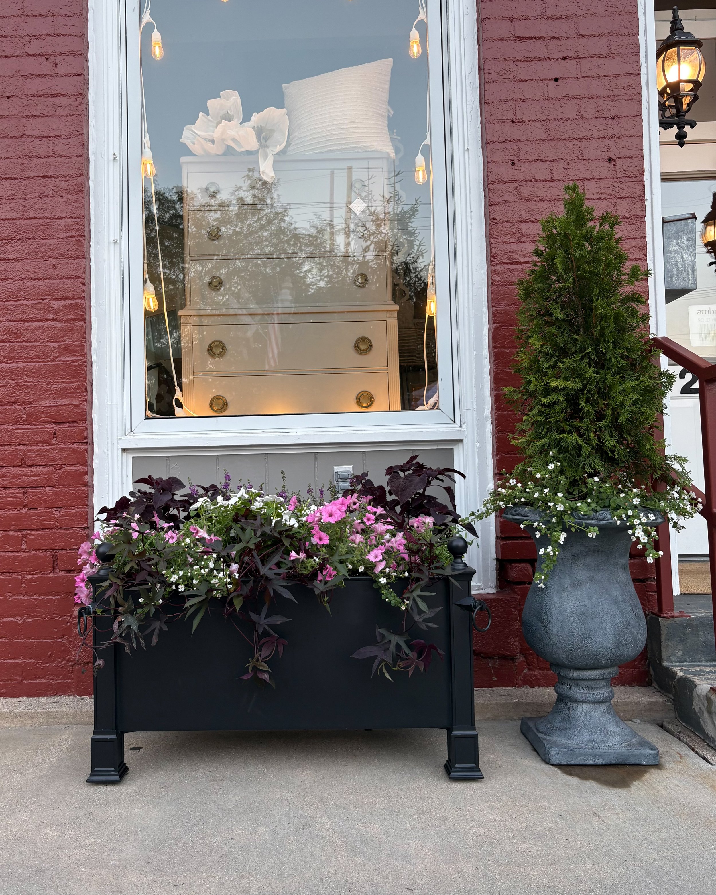 Small business storefront with coordinated seasonal planters