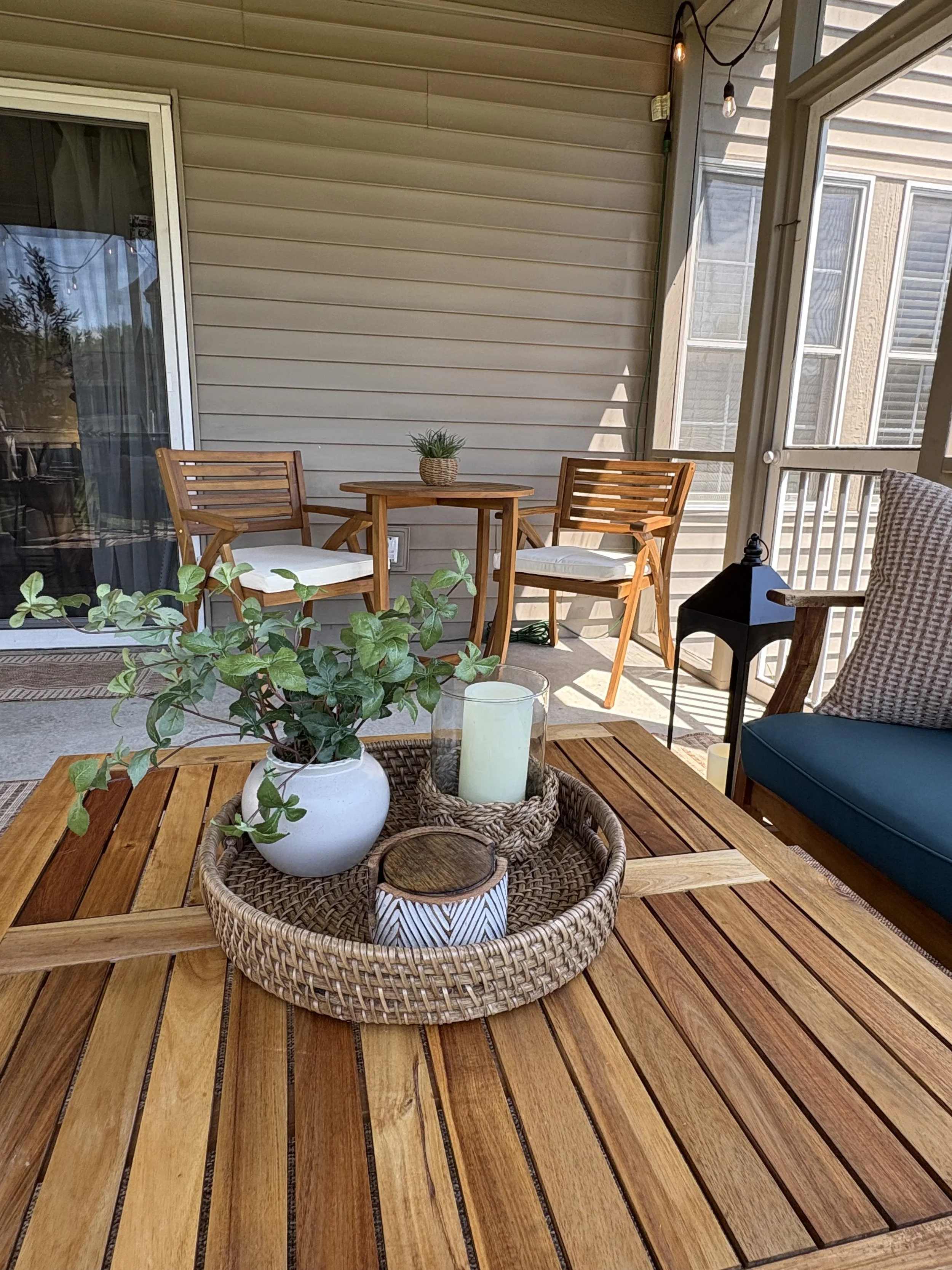 Styled outdoor living area with seating, rug and decorative accents