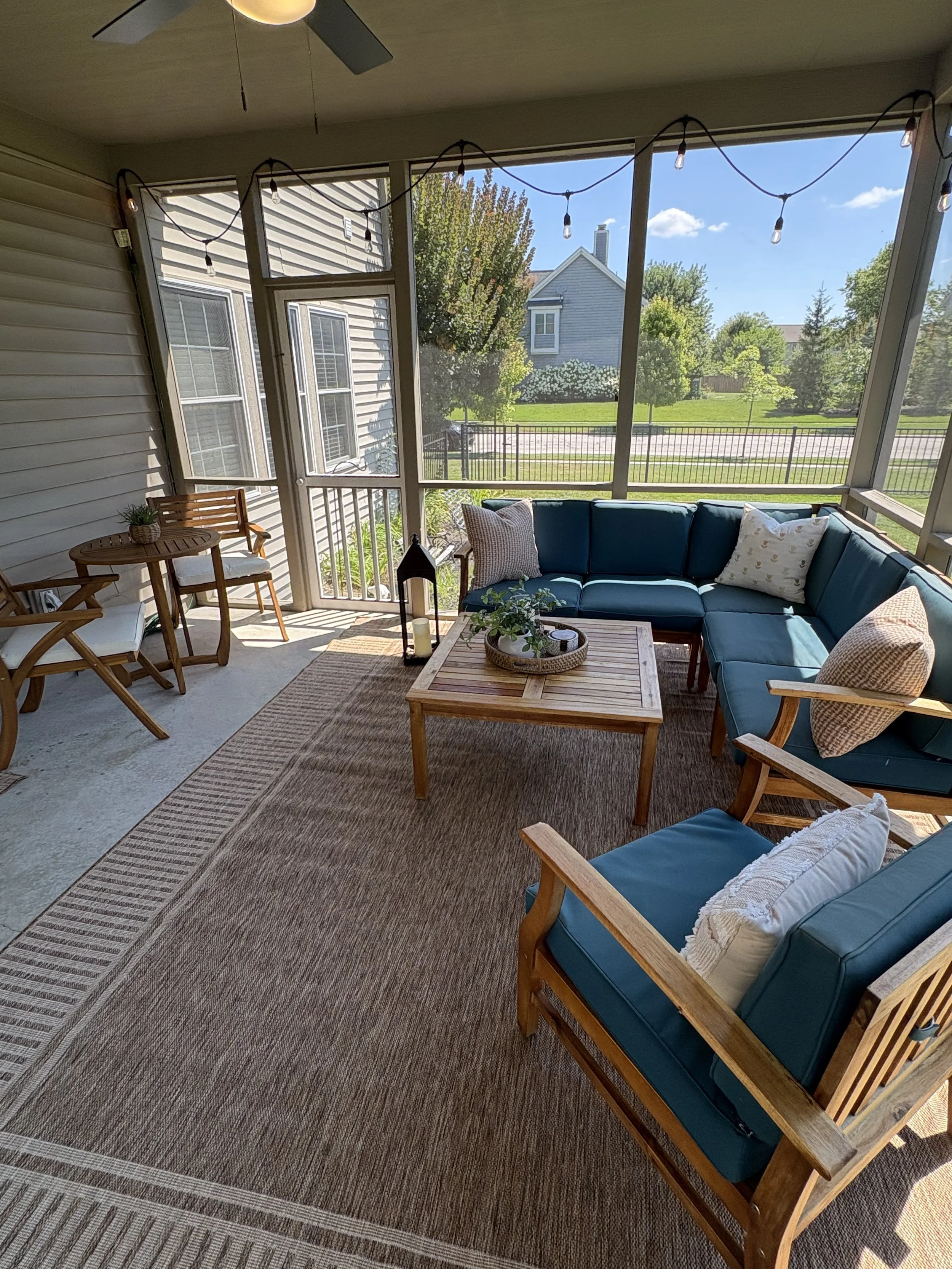 Professionally styled screened porch with outdoor seating