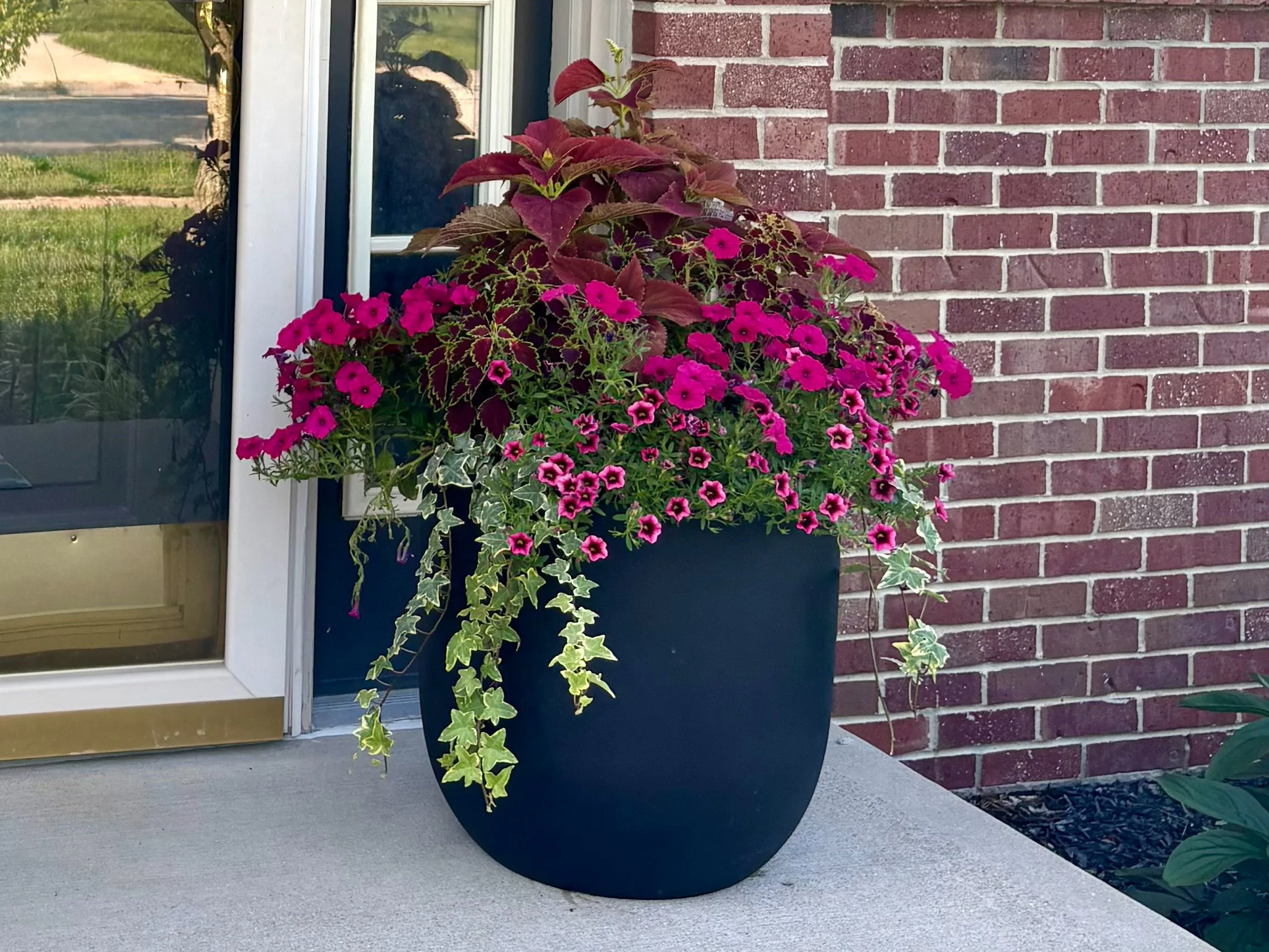 Professionally designed seasonal container garden at a front entrance