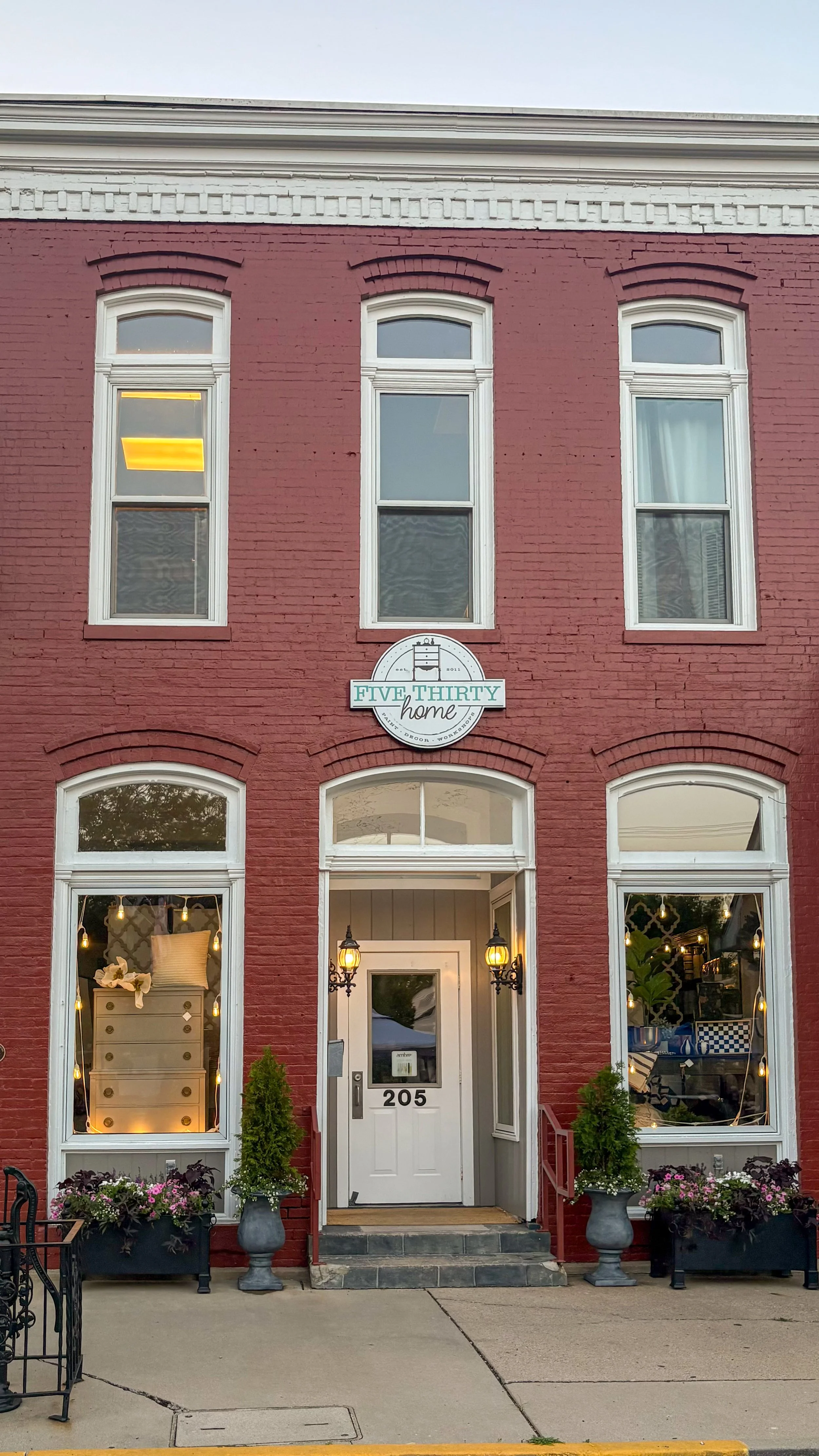 Storefront styling and seasonal planters by Curated Entry Co.