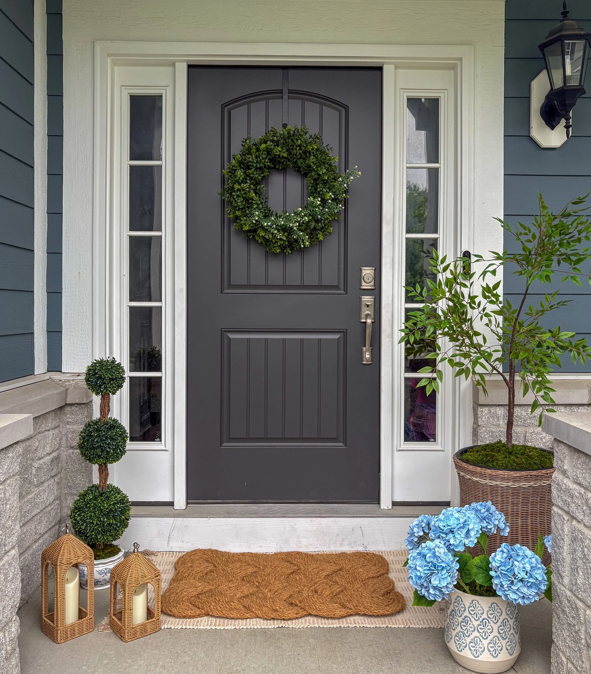 Professionally styled front entrance with wreath and lanterns