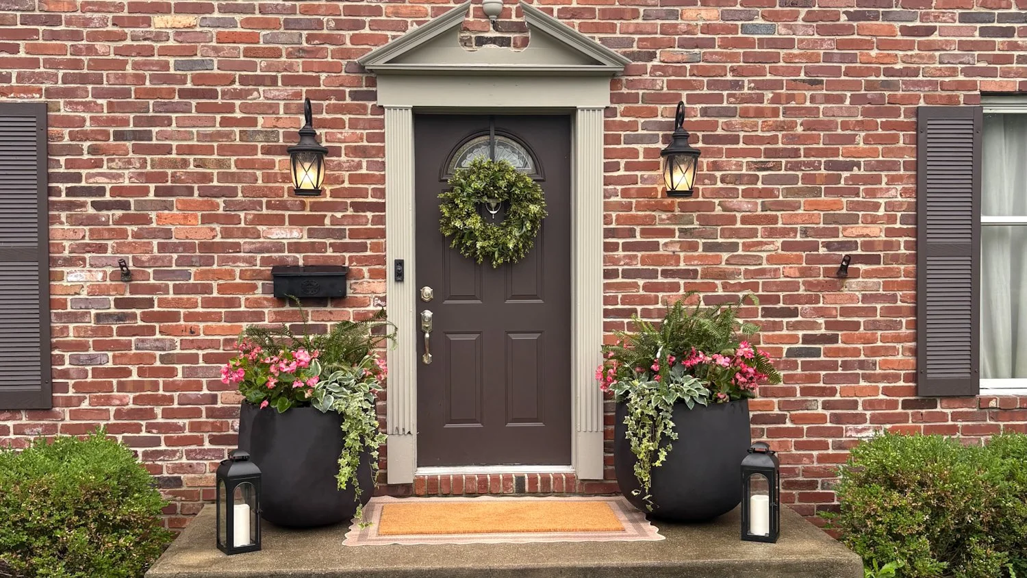 Curated seasonal décor and planters styled at a front entrance