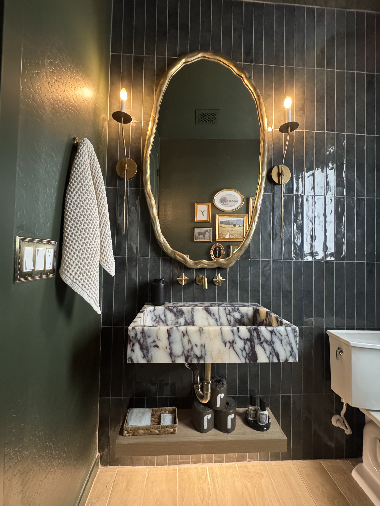Calacatta Viola marble vanity with wall-mounted brass faucet