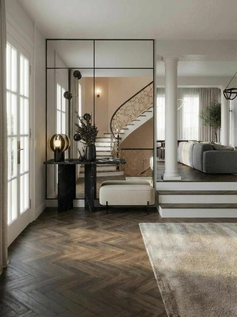 Grand entryway with a dramatic mirrored grid wall, black marble console, and structural columns