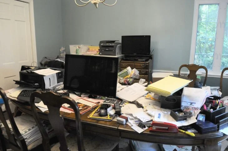 Before: dining table covered in papers and equipment