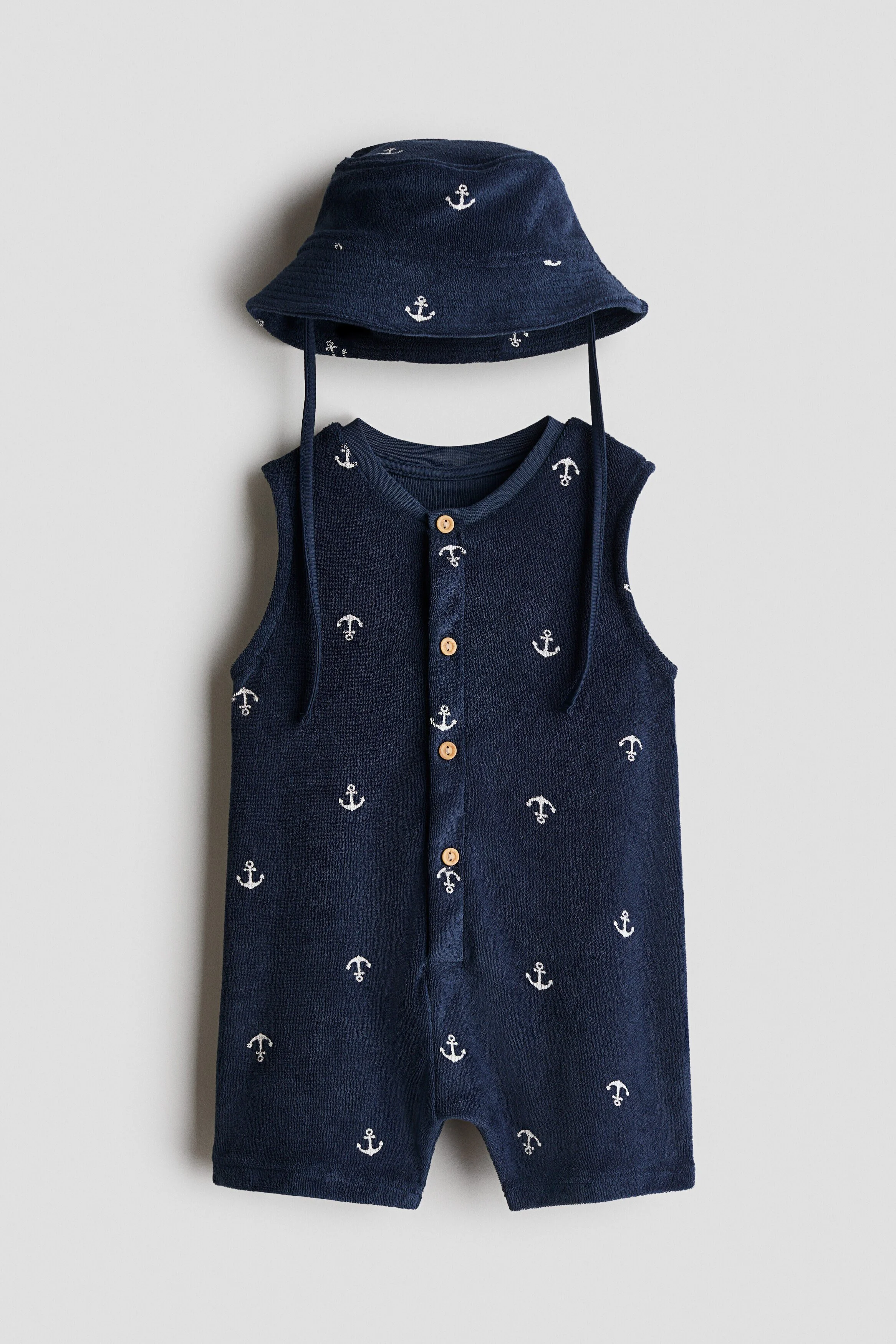 Navy anchor-print romper and matching bucket hat used as the test product