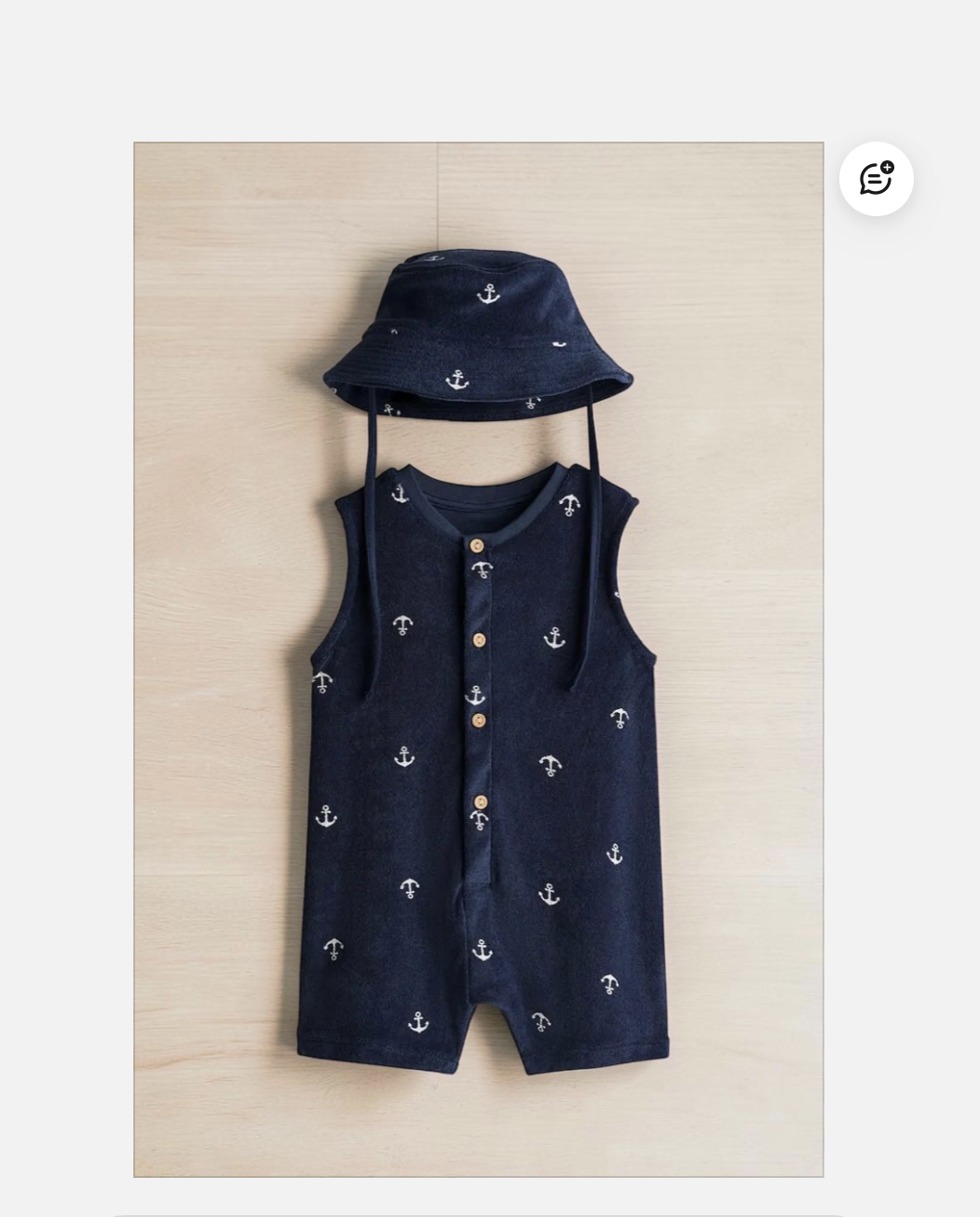 Photoroom interface showing the original navy romper before a background swap