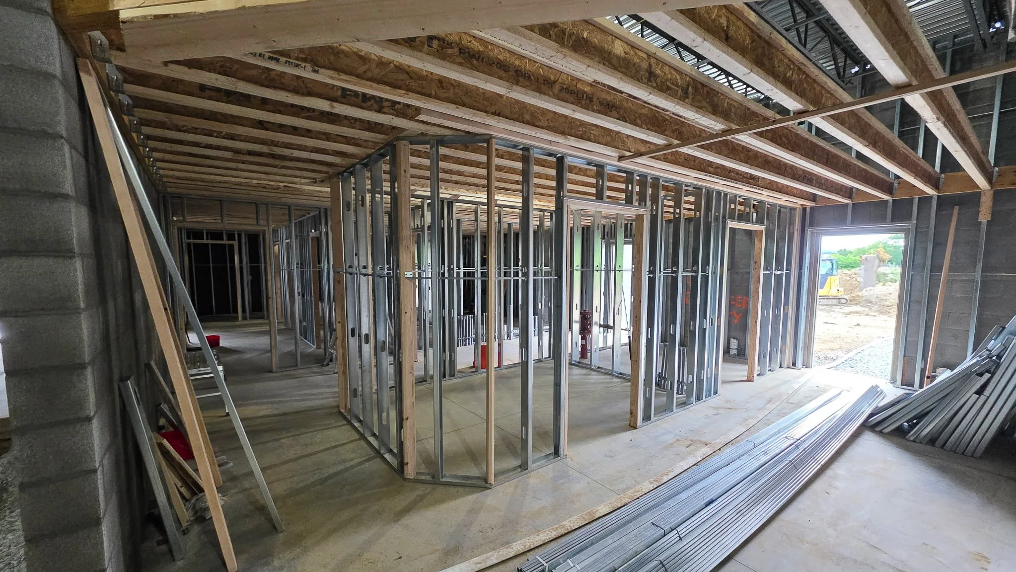 Steel stud interior walls framed under wood floor joists inside the Common Ground Kitchen and Taps restaurant under construction in McMurray, PA.